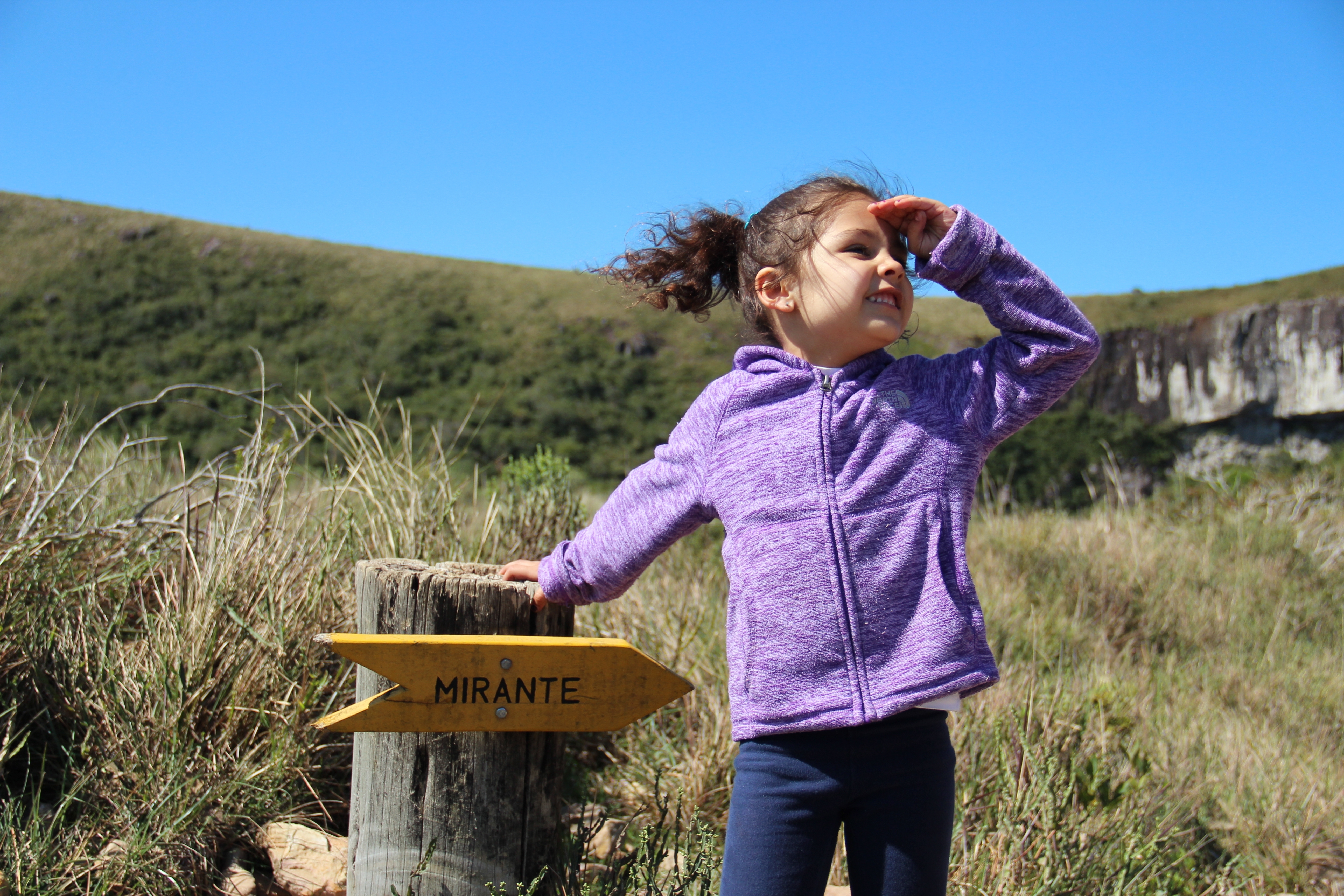 preschooler with trail sign